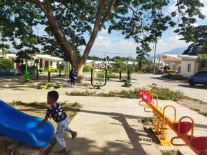 a young boy playing on a slide at a playground at Malvar Lodge in San Isidro Sur