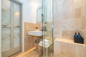 a bathroom with a toilet and a sink and a shower at Kampenkliff ehemals Walter´s Hof in Kampen +13 photos