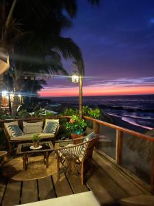 a patio with a table and chairs and a view of the ocean at Los Corales in Máncora