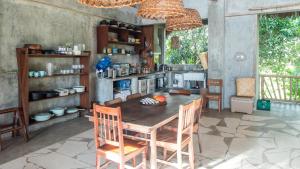 a kitchen with a table and chairs in a room at Baia Nest Main House Self Service BNB Near the Beach in Gubat