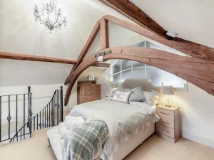 a bedroom with a bed in a attic at The School Room in Dymock