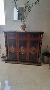 a wooden cabinet with a vase on top of it at Apartment in Nador in Nador