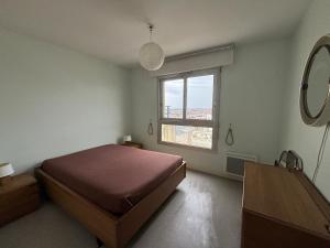 a bedroom with a bed and a window at Appartement Les Sables-d'Olonne, 3 pièces, 4 personnes - FR-1-197-207 in Les Sables-d'Olonne