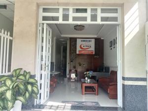 an open door of a building with a table and chairs at 18 Homestay Star's in Can Tho