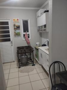 a kitchen with a table and a stove in it at Casa RibeirãoPreto in Ribeirão Preto