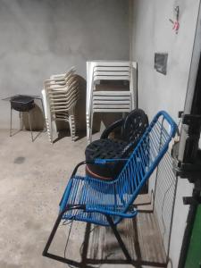 a group of chairs sitting next to a wall at Casa RibeirãoPreto in Ribeirão Preto