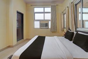 Ein Bett oder Betten in einem Zimmer der Unterkunft OYO Hotel A.K Vilas