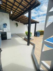 a patio with a pergola in a house at Casa Aconchegante com Piscina in Petrolina