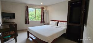 En eller flere senge i et værelse på Tea Dale - All rooms with Tea Estate view