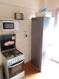 a kitchen with a refrigerator and a stove and a microwave at F1 Cosy in Dakar