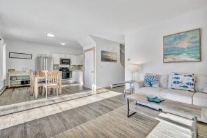 a living room with a couch and a table at Ocean View West Duplex with Walk to Crescent Beach in Owls Head