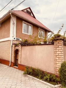 a brick house with plants on the side of it at Guest House Crocus in Bishkek