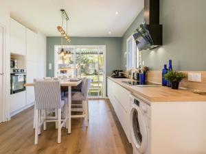 a kitchen with a table and a dining room at Maison rénovée 2023 à 300m de la mer avec terrasse, jardin clos, clim et wifi - FR-1-306-1270 in Saint-Brevin-les-Pins