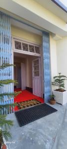 a front door of a house with a red carpet at Shree Niwas in Darjeeling