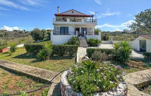 a large white house with a red roof at Nice Home In Theologos With Wi-fi in Theológos