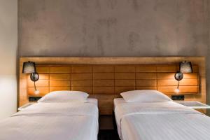 Cama ou camas em um quarto em Moxy Warsaw Praga
