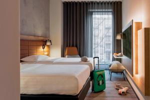 Cama ou camas em um quarto em Moxy Warsaw Praga