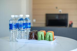 a tray of chocolate and bottles of water on a table at Bahagia Villa in Kuah