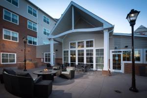 a building with a patio with chairs and tables at Residence Inn by Marriott Columbus Polaris in Columbus