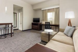 a living room with a couch and a desk at Residence Inn by Marriott Columbus Polaris in Columbus