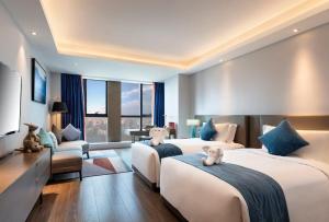 Postel nebo postele na pokoji v ubytování Changsha Zealandia Serviced Apartment