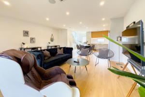 a living room with a couch and a table at Spacious Townhouse in Epsom School Zone in Auckland