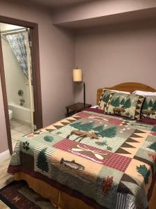 a bedroom with a bed with a quilt on it at Big Bear Lake Front Lodge in Big Bear Lake