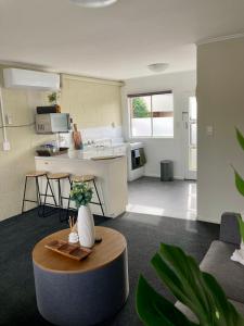 a living room with a kitchen and a table in a room at 108 by the Lake in Taupo