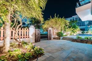 a garden with a fence and a patio at FLC Grand Villa BT35.06 in Sầm Sơn