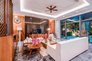 a living room with a white couch and a table at FLC Grand Villa BT35.06 in Sầm Sơn
