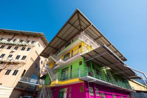 a colorful building in the middle of two buildings at Bahagia Villa in Kuah