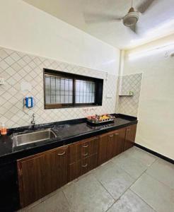 a kitchen with a sink and a counter top at Red Velvet Villa in Kīhīm