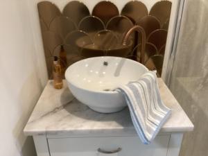 a white bowl sink on a counter in a bathroom at Forest Heath Holidays - The Nook in Ringwood