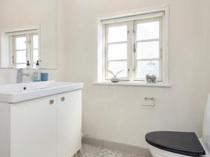 a bathroom with a toilet and a sink and a window at 10 person holiday home in Harboøre-By Traum in Harboør +34 photos