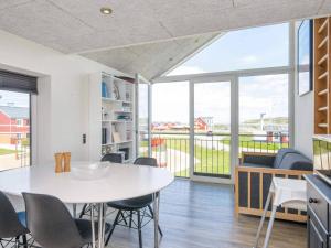 a dining room with a white table and chairs at Holiday home Lemvig XLIV in Lemvig