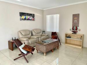 a living room with a couch and a table at Nice and Neat House for your Journey - Renovated in Perth