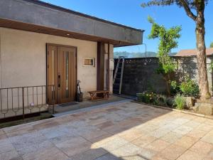 a house with a porch with a wooden door at Gohuku - Vacation STAY 41804v in Kami-ichi