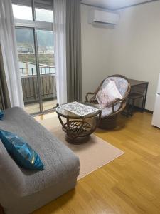 a living room with a couch and chairs and a window at Gohuku - Vacation STAY 41804v in Kami-ichi