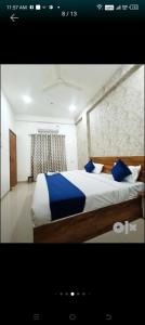 印多爾的住宿－Hotel 7star near airport，一间卧室配有一张带蓝色枕头的大床