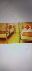 a room with two bunk beds with red sheets at Hotel 7star near airport in Indore