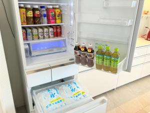 an open refrigerator filled with lots of drinks at -Villa Rikyu- 離宮 in Miyako-jima