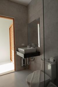 a bathroom with a sink and a toilet and a mirror at Harmony Sea View Villa in Chaweng Noi Beach