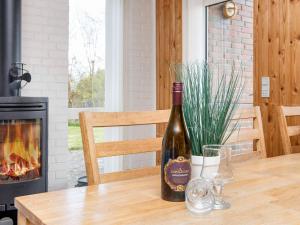 una botella de vino en una mesa con chimenea en 7 person holiday home in Struer, en Humlum