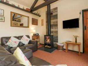 a living room with a couch and a fireplace at Bowling Green Cottage in Redruth