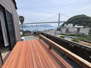 a wooden deck with a view of a bridge at 海峡別荘 in Shimonoseki