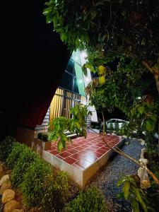 a brick walkway with a bench in a garden at HOLY VILLA A Frame 3beds 1sofa bed 1bathroom in Kampot