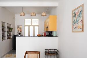 a kitchen with white walls and a counter top at Rajan House in Jaipur