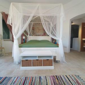 Bett mit Baldachin in einem Zimmer in der Unterkunft Pietra Bianca in Koríthion