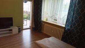 a living room with a television and a window at Giżycko WP30 in Giżycko