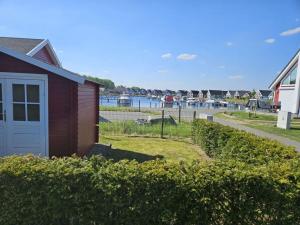 a house with a garage next to a marina at Beaver Modern retreat in Berg